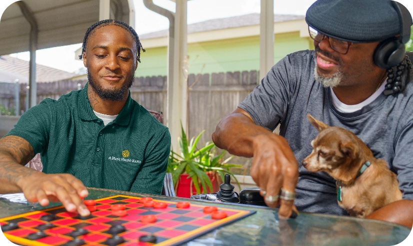 Caregiver playing checkers with an older man.