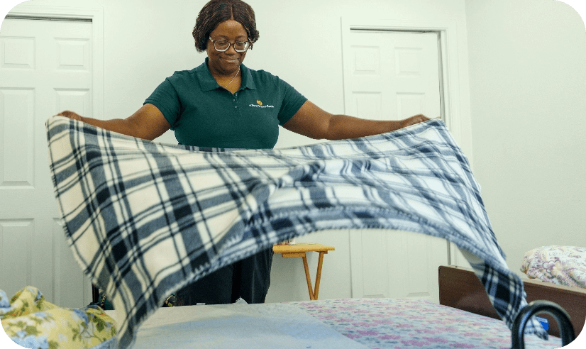 Caregiver making a bed