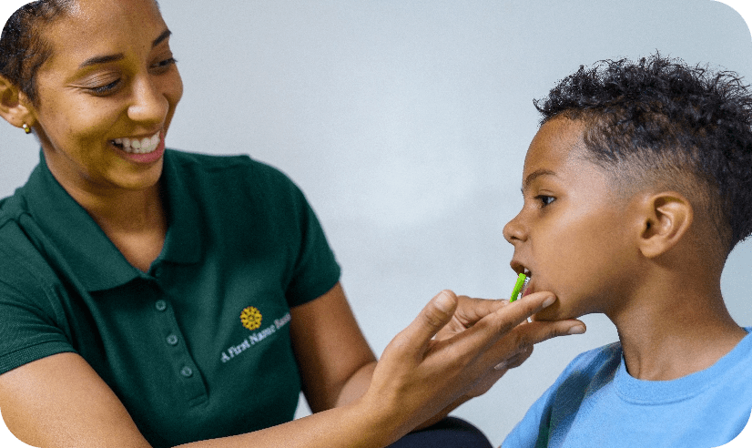 Caregiver brushing childs teeth